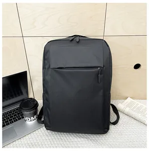 Close-up of black waterproof business backpack on wood desk with laptop and coffee