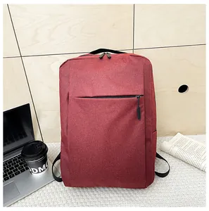 Water-resistant red business laptop backpack placed in a cozy home office setting