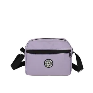 Light purple oxford fabric crossbody bag with adjustable shoulder strap and sport logo