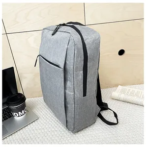Close-up of minimalist gray business backpack featuring polyester texture and hidden pockets
