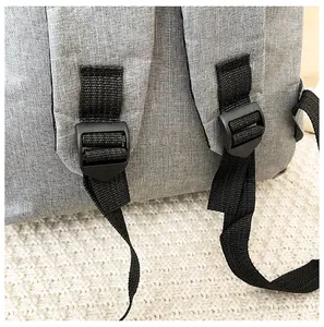 Detail of adjustable black nylon shoulder strap and grey fabric on a business backpack