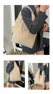 Close-up of beige corduroy tote bag showing vertical texture and Fashion Instinct label