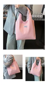 Detailed view of pink pleated corduroy tote bag with Fashion label on model shoulder