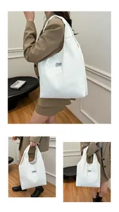 Detail of white corduroy tote bag showing ribbed texture and Fashion Instinct label
