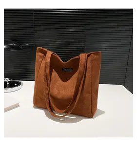 Détail du sac cabas en daim marron avec texture de qualité et étiquette Fashion Instinct