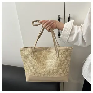 Detail of hand-woven straw tote with V-shaped texture and beige faux leather base