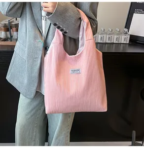 Detailed texture of pink corduroy tote bag featuring a Fashion Instinct label