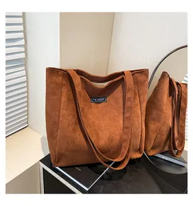 Détail du sac cabas en daim caramel avec étiquette Fashion Instinct et texture douce