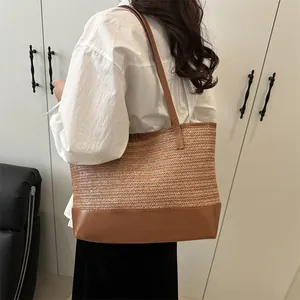 Large straw tote bag with brown leather contrast and shoulder straps for women