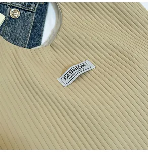 Close-up of beige corduroy tote bag texture with Fashion Instinct woven label