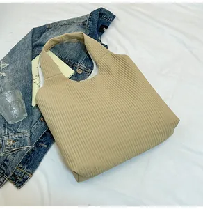 Detailed top view of a pleated khaki corduroy tote bag with minimalist aesthetic