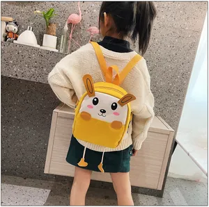 Détail du sac à dos lapin jaune avec pieds 3D porté par une petite mannequin