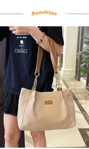 Detailed texture of beige corduroy tote bag with brown leather chain strap and fashion patch
