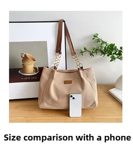 Detail of beige corduroy tote bag showing large capacity with smartphone comparison