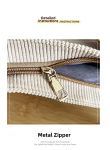 Close-up of golden hardware zipper and textured corduroy fabric on a cream tote bag