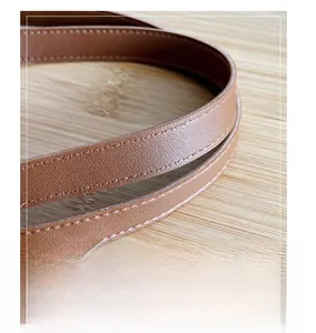 Detailed close-up of the brown lychee pattern leather strap with premium stitching