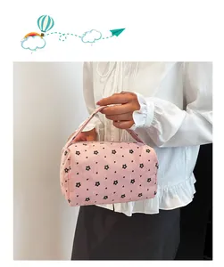 Detailed shot of pink corduroy floral handbag with textured finish and soft handle