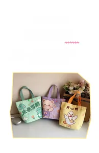 Detail of cute cartoon canvas bags with snap buttons in dinosaur and bear designs
