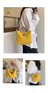 Detail of yellow corduroy tote bag featuring a Myron Bear patch and pink leather chain strap