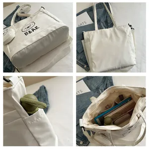 Detailed four-view composite of white canvas tote bag with bear print and internal pockets