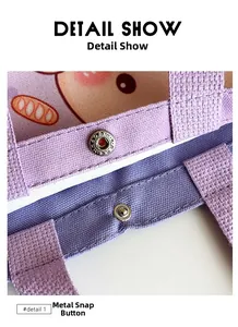 Detail shot of the metal snap button closure on a purple canvas gift tote bag
