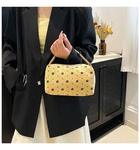 Floral corduroy handbag featuring cute daisy patterns shown in a lifestyle hand-held view
