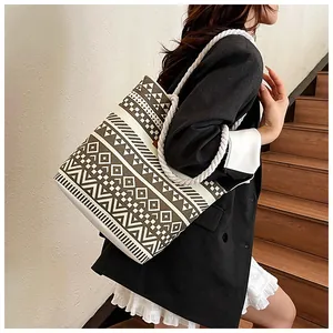 Detailaufnahme einer großen Canvas-Tasche mit Ethno-Muster und gewebten Seilgriffen