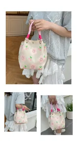 Detail of pink knotted rope handle and thick knit floral pattern on a bucket bag