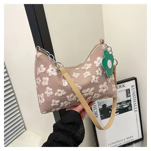 Detail of floral canvas tote bag featuring 3D puff flowers and a green flower tag