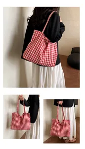 Detail of red and white gingham fabric tote bag with a charming bow decoration