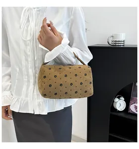 Detail of floral corduroy organizer bag featuring daisy print and sturdy top handle