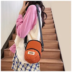 Detail of orange nylon crossbody bag with adjustable strap and front zipper pocket