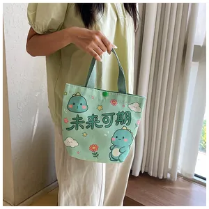 Detail of light green canvas bag with cartoon dinosaur print and button closure