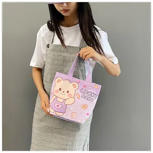 Close-up of cute cartoon bear print and Lucky Baby text on purple canvas tote bag