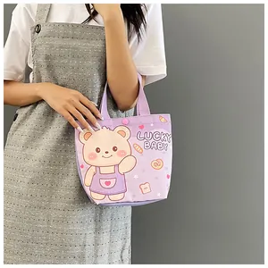 Detail of purple canvas tote bag with lucky baby cartoon bear and pink snap button