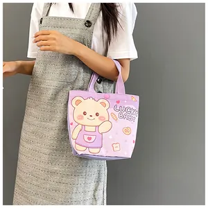 Detail of purple canvas tote with cartoon bear print and secure snap button closure