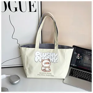 Detail shot of canvas tote bag featuring a cute panda print and premium corduroy lining