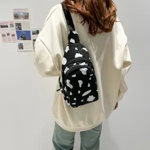 Minimalist black and white cow print canvas chest bag for women with adjustable strap