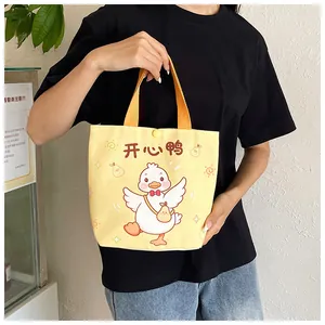 Detail of yellow canvas gift bag with cartoon duck illustration and snap closure