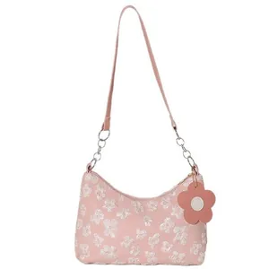 Pink canvas crossbody tote bag with white 3D flower embroidery and adjustable strap