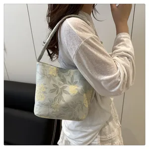 Detail of embroidered floral pattern on textured canvas Chinese style bucket bag