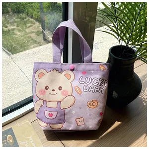 Detail of purple canvas gift bag featuring a lucky baby bear print and secure snap button
