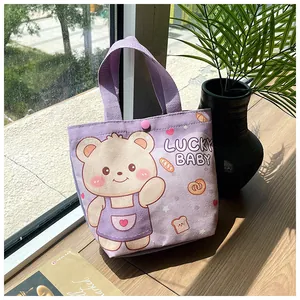 Close-up of purple canvas gift bag with cartoon bear and snap button on a sunny windowsill