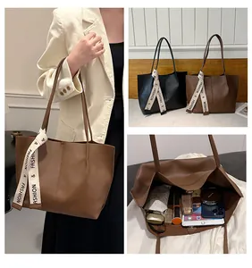 Detailed view showing large capacity interior and textured PU leather of the tote bag