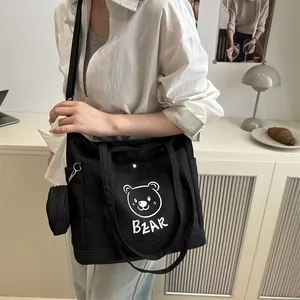 Large black canvas tote bag with white bear print and small round hanging coin purse