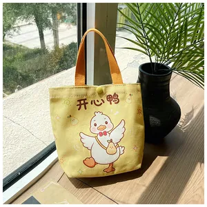 Close-up of cute cartoon duck canvas tote bag with snap button and orange handle