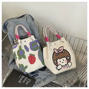 Detail of knitted bucket bags with flower and cartoon prints in a shopping cart