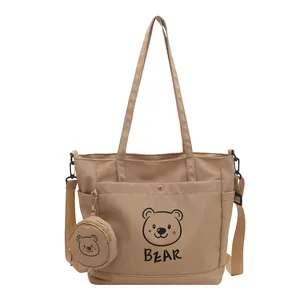 Large khaki canvas tote bag with bear print, including a small round pouch and long strap