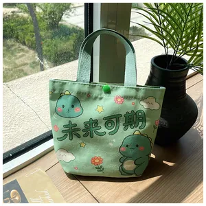 Close-up of green canvas gift bag with cartoon dinosaur and snap button closure