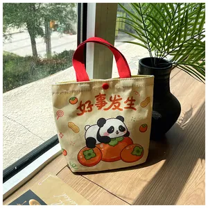 Detail of canvas bag with cute panda and persimmon print on a sunlit wooden windowsill
